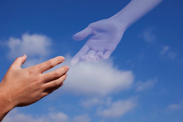 Two hands reaching towards one another